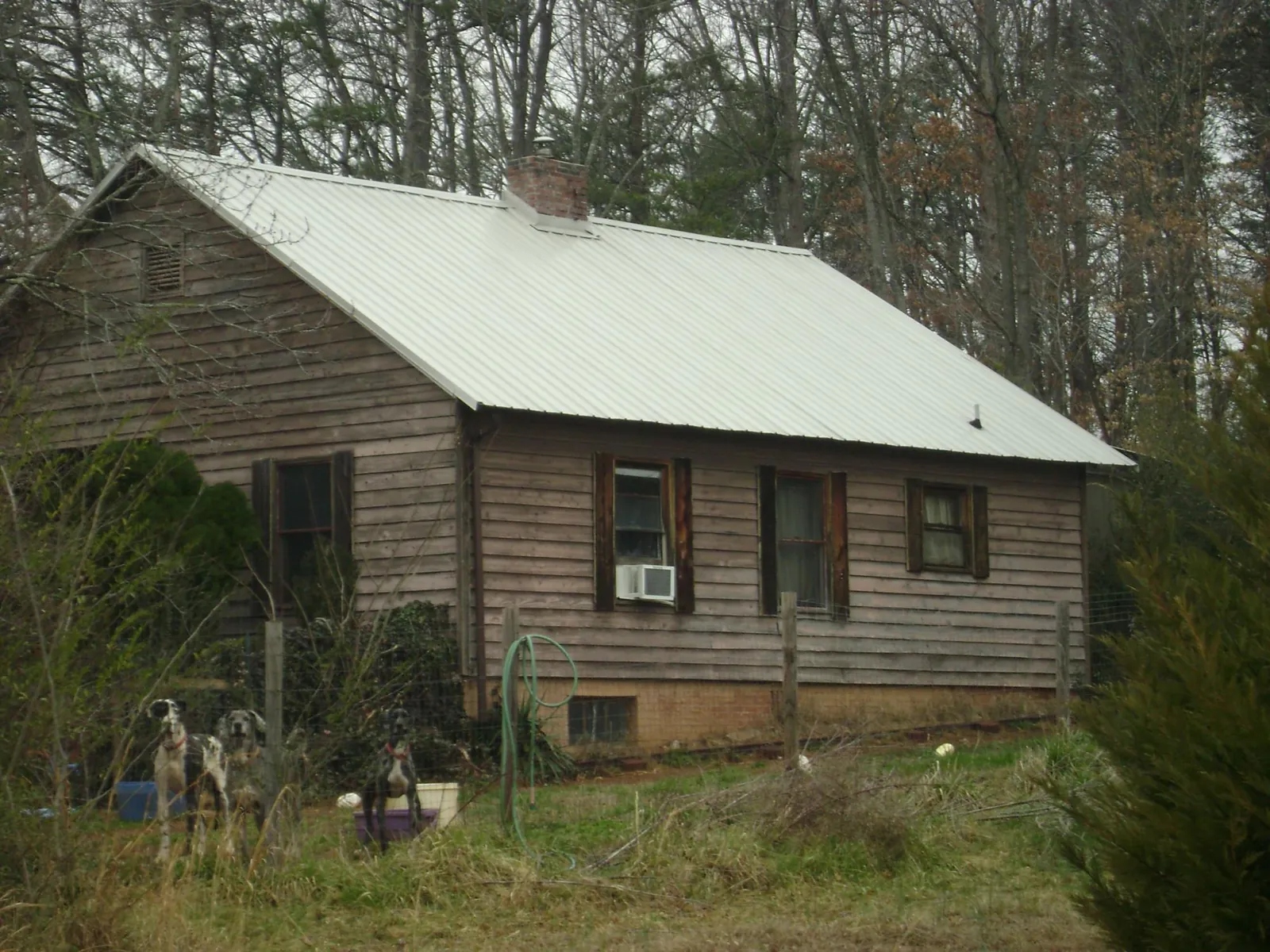 White metal roof on an old wood sided farmhouse, from a Metal Roof Installation job in East Bethany